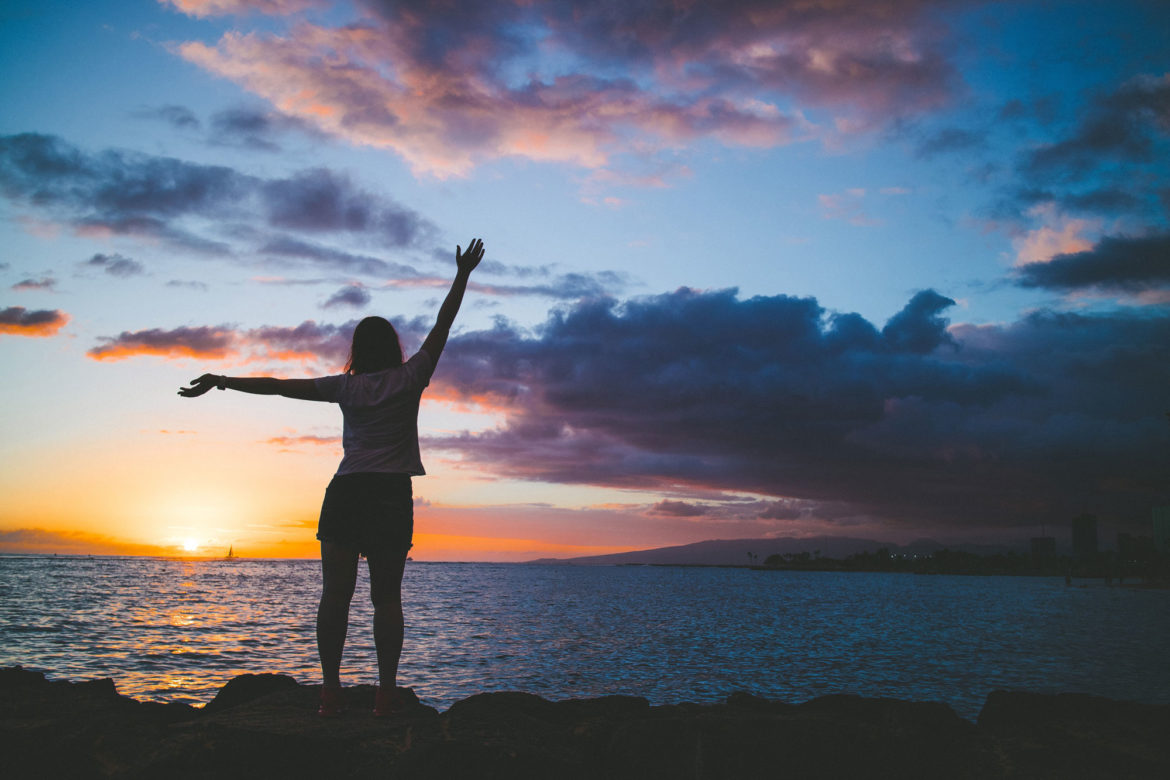 Silhouette of girl enjoying Hawaiian sunset in Honolulu